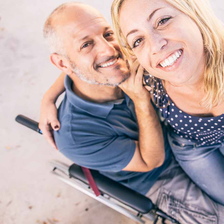 Man with multiple Sclerosis sat in wheelchair with wife