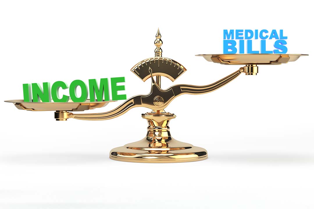 Income and Medical Bills on balancing scales 