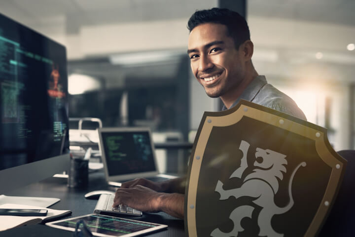 IT contractor with a shield featuring the Black Lion Insurance logo, symbolising income protection insurance