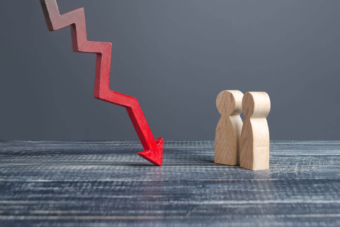 Two figures facing a downward arrow, representing the financial impact of losing a shareholder